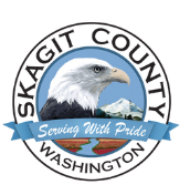 The logo for skagit county washington is a bald eagle with a mountain in the background.