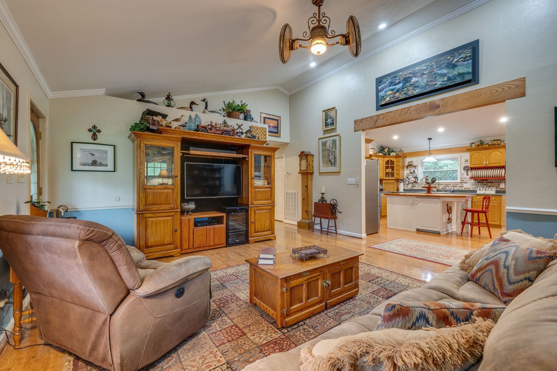 Living room with a couch , chair , coffee table and television.