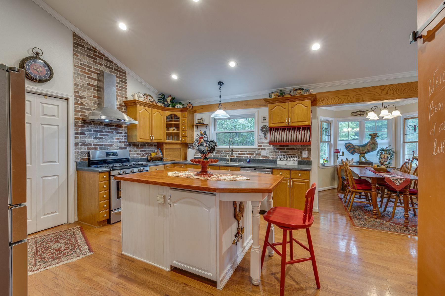 Kitchen with a large island and a red chair.