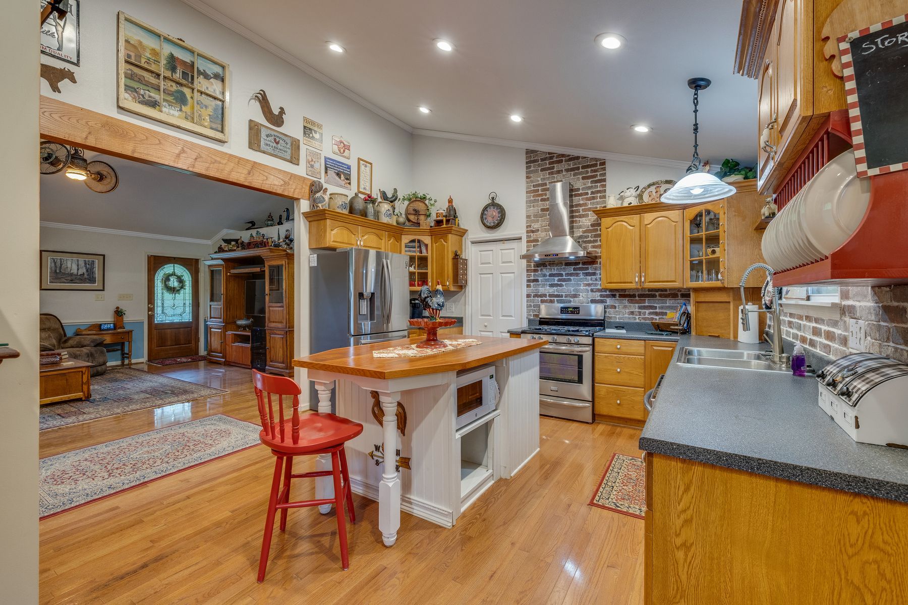 Kitchen with a large island and a red chair.