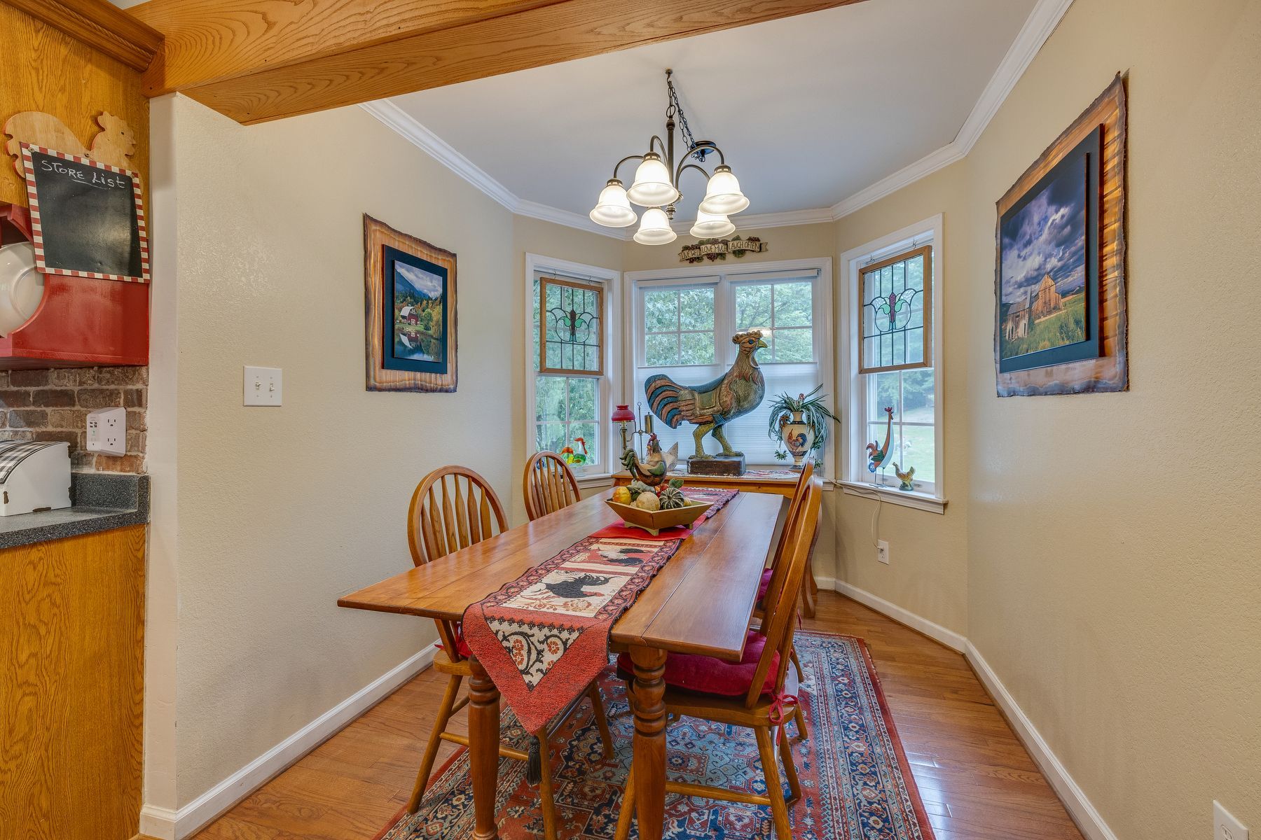 Dining room with a table and chairs and a chandelier.