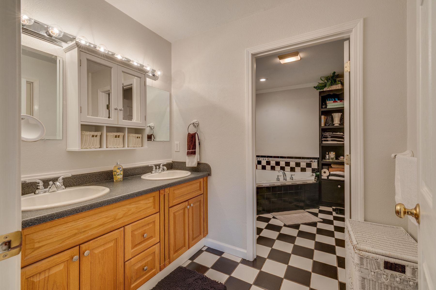 Bathroom with two sinks and a checkered floor