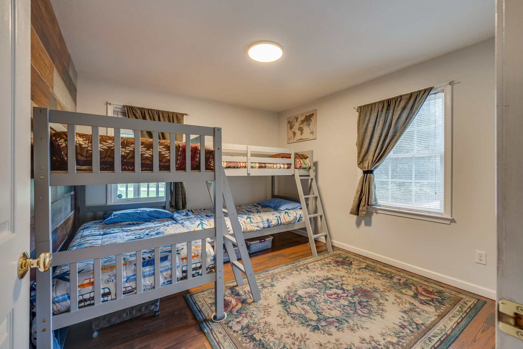 Bedroom with two bunk beds and a rug.