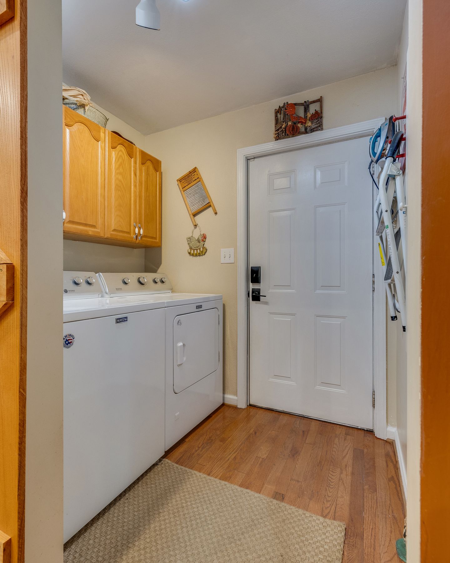 Laundry room with a washer and dryer and a door