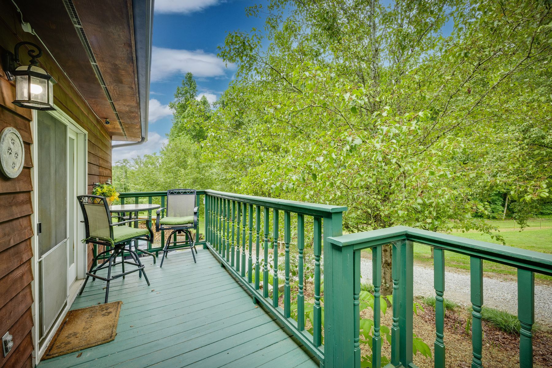 Large deck with a table and chairs on it.