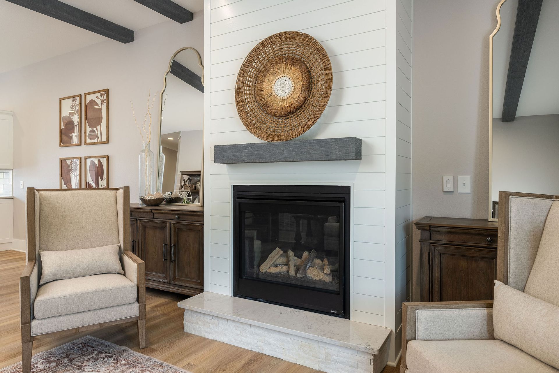 A living room with a fireplace , chairs , and a couch.