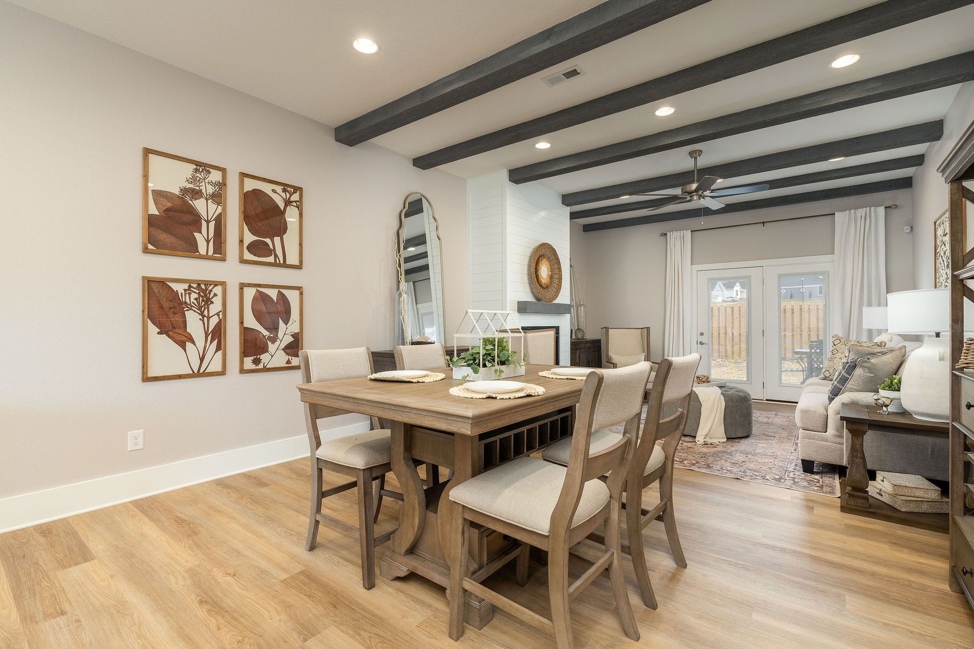 A dining room with a wooden table and chairs in a house.