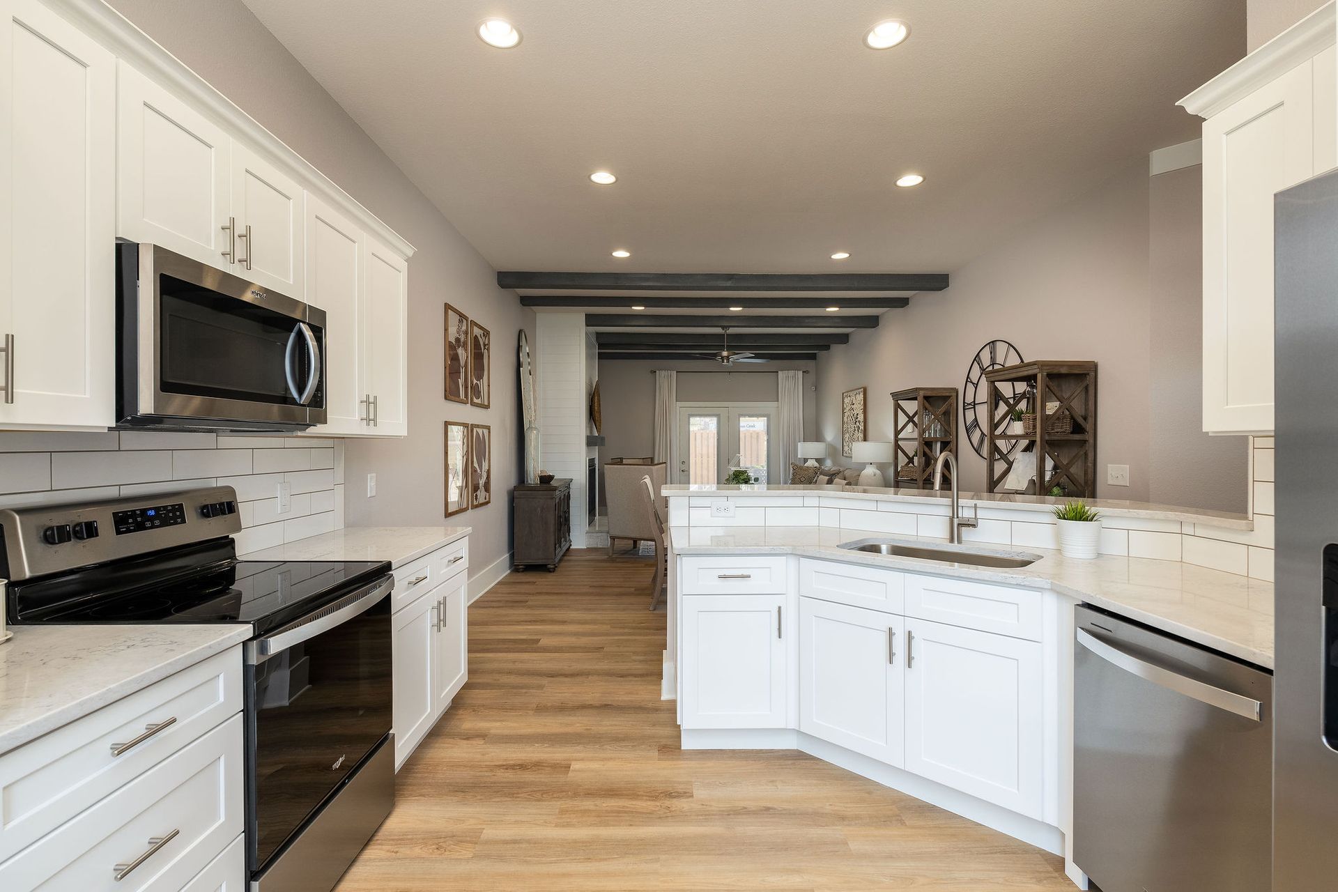 A kitchen with white cabinets and stainless steel appliances.