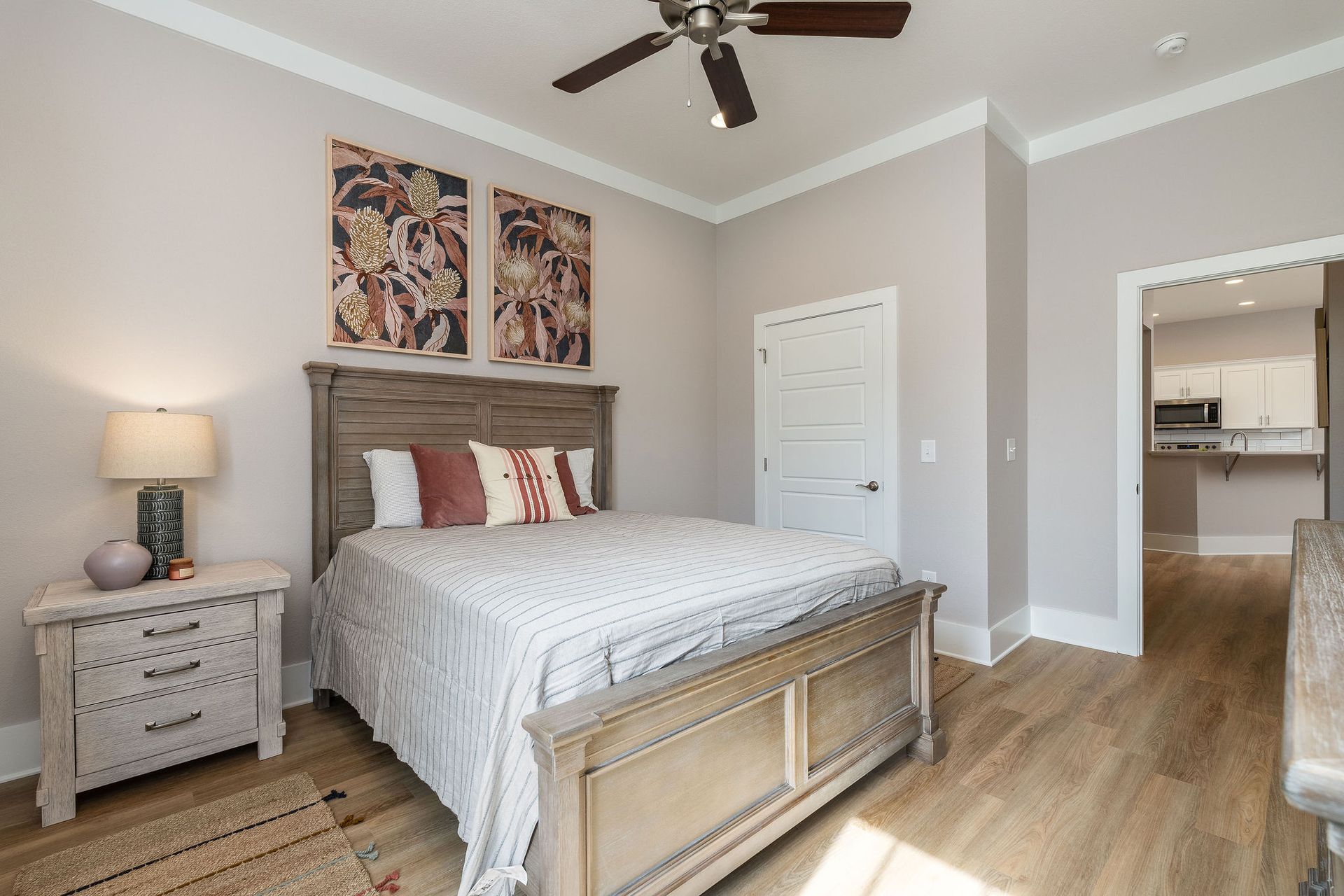 A bedroom with a large bed and a ceiling fan.