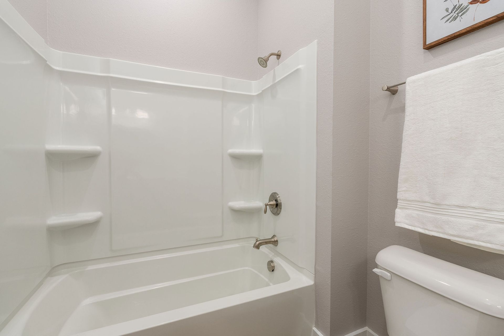 A bathroom with a tub , toilet and shower.