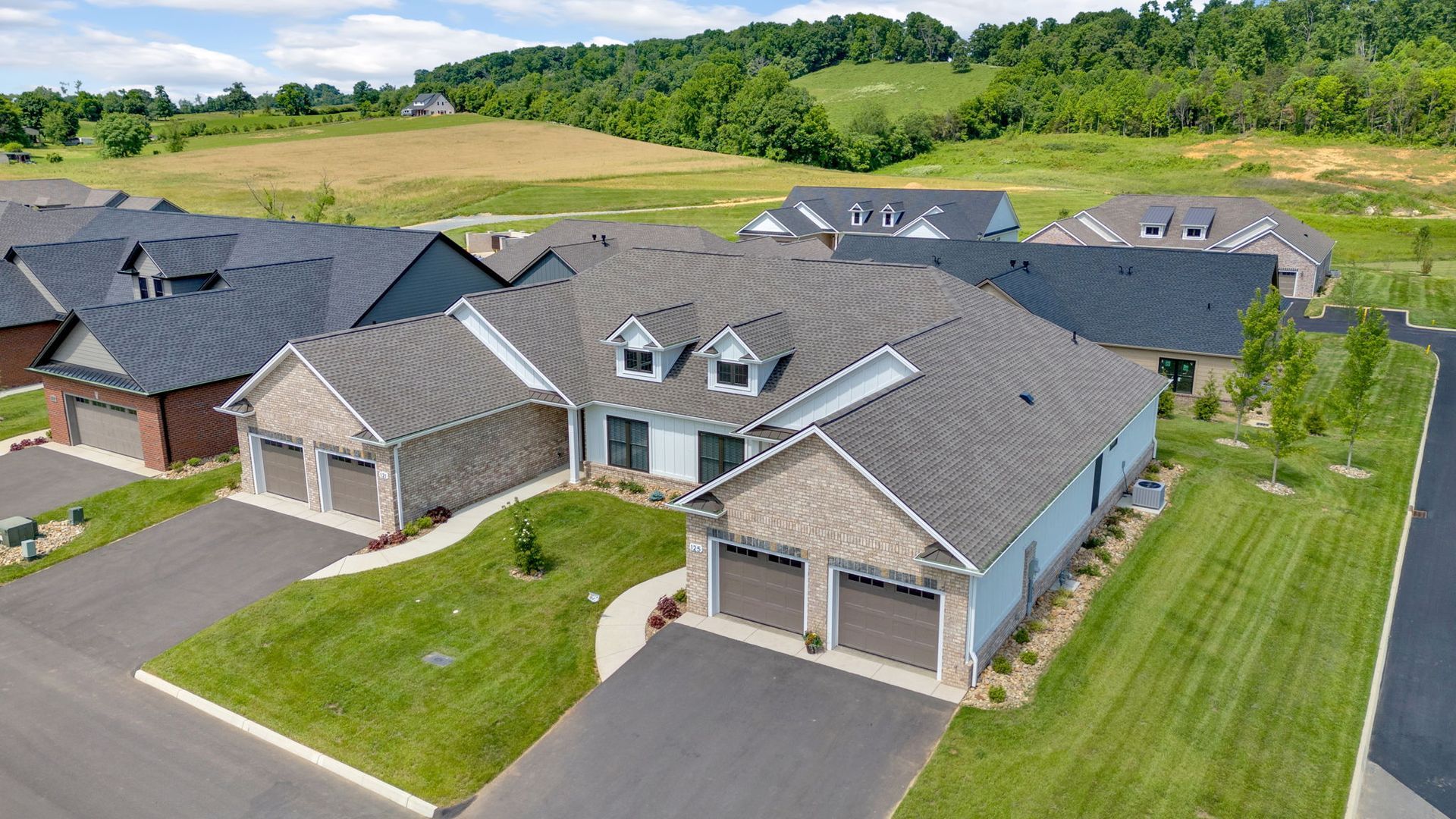 An aerial view of a residential neighborhood with houses and garages.