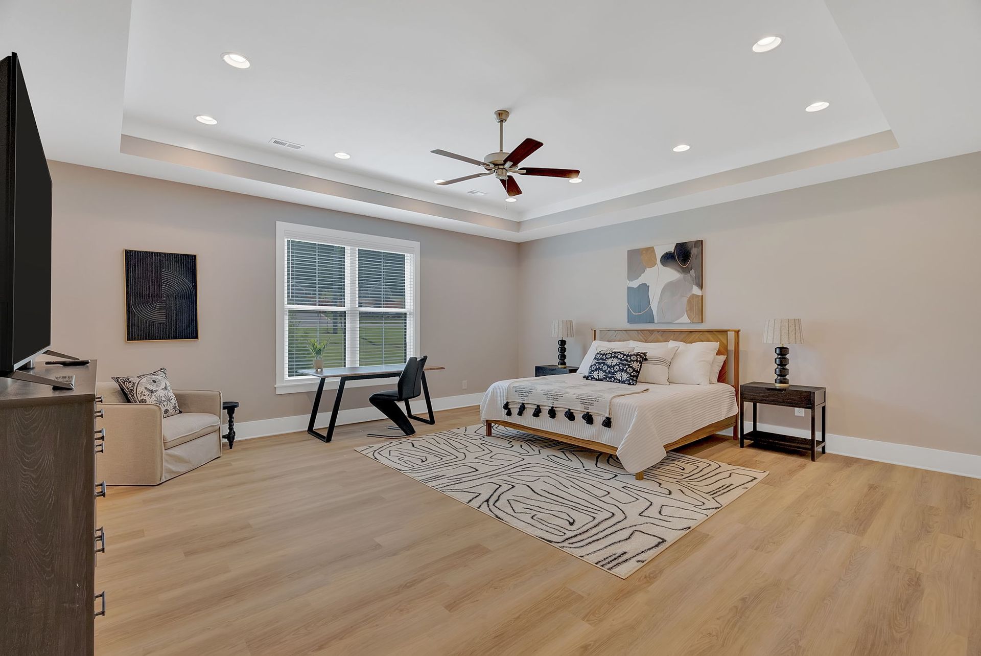 A bedroom with a bed , desk , chair and television.