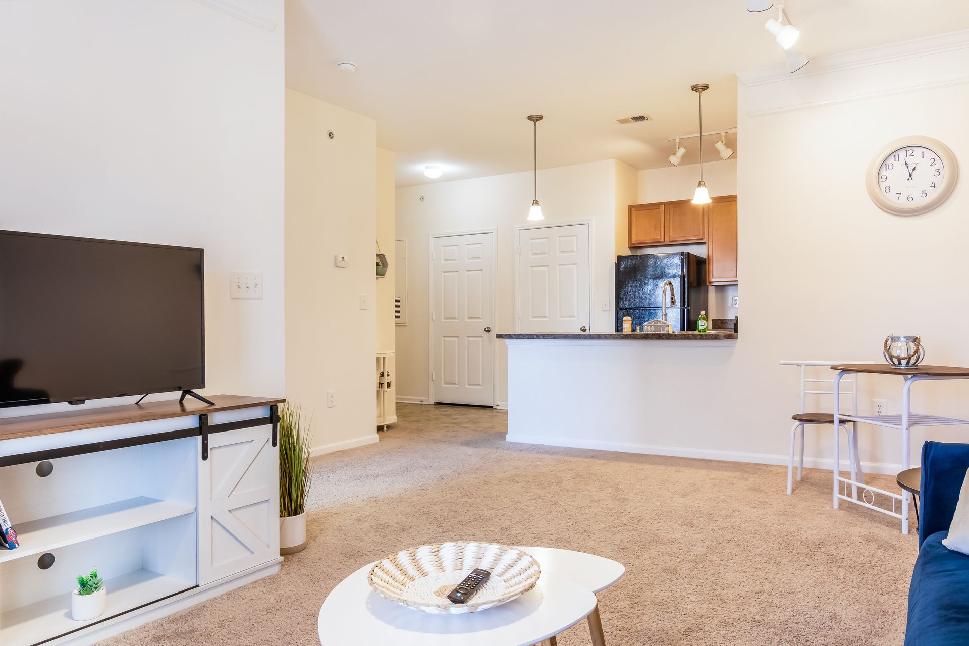 Living room with a flat screen tv and a clock on the wall in Johnson City