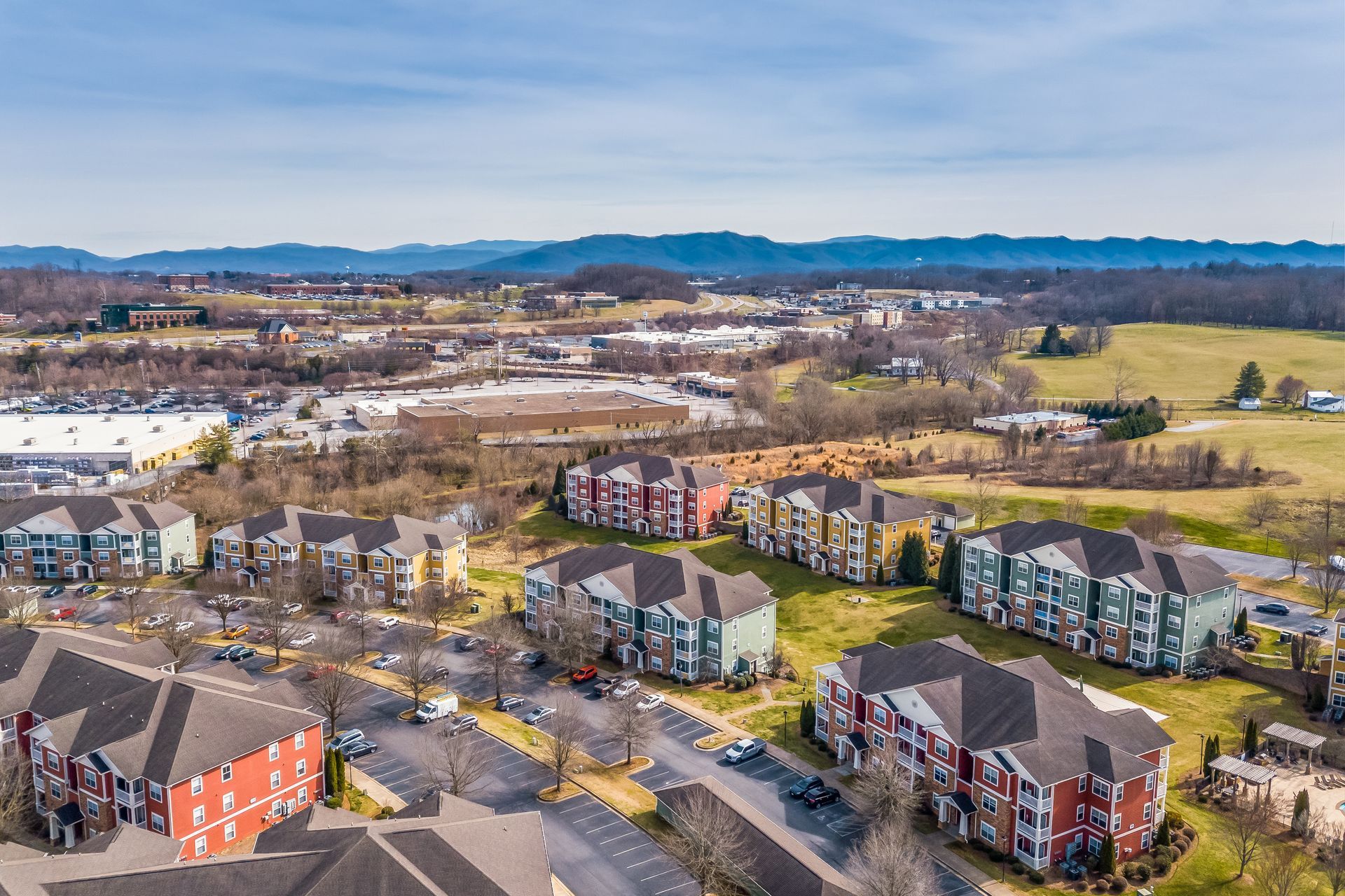 Aerial view of a residential area with a lot of buildings and mountains in the background in Johnson City