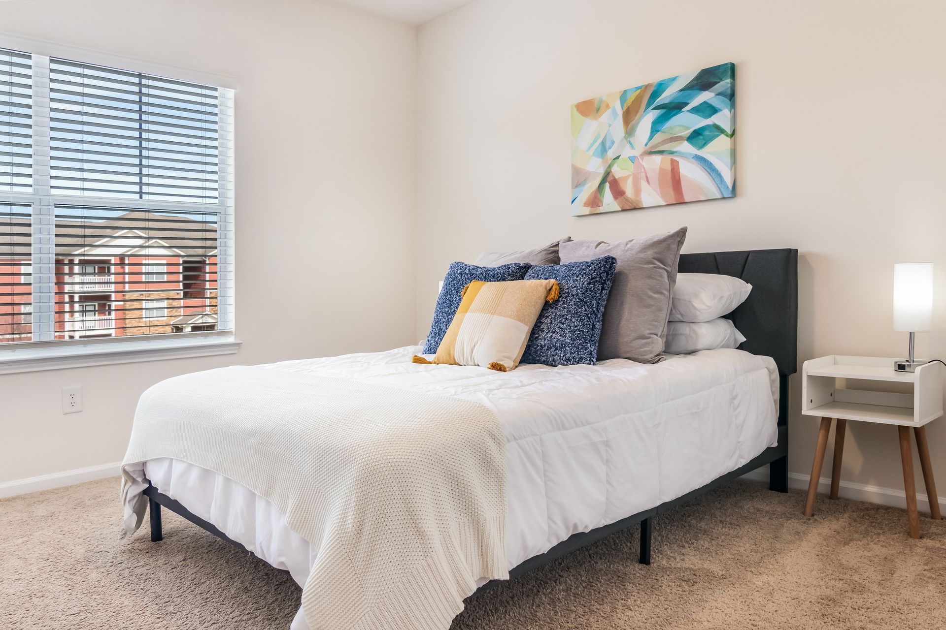 Bedroom with a queen bed , nightstand , lamp and window i Johnson City