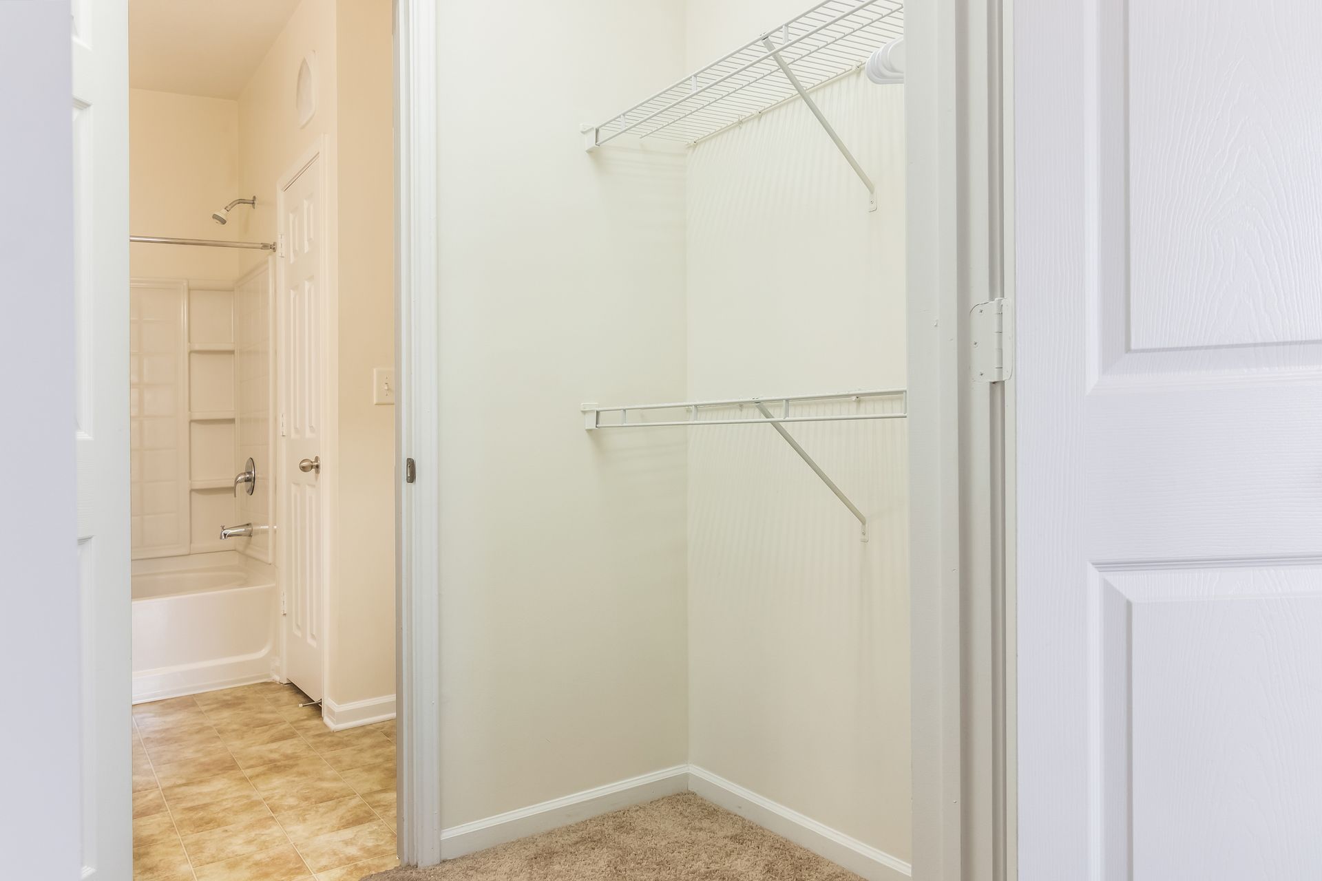 Walk in closet with a bathroom in the background in Johnson City.