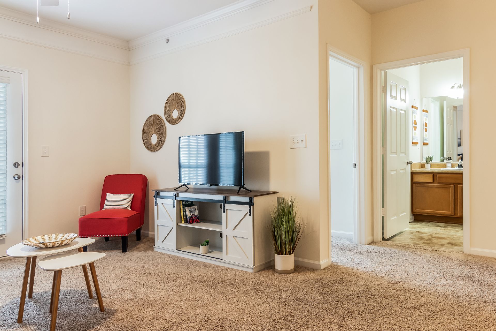 Modern furnished living room with a television , chair , and table in Johnson City.