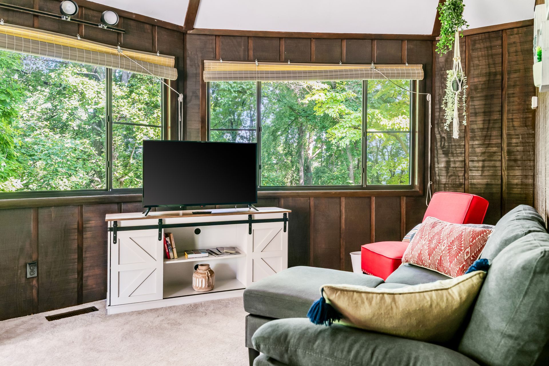 A living room with a couch , chair and television.