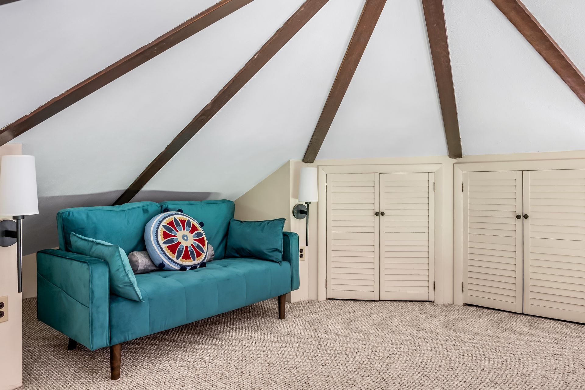 There is a blue couch in the middle of the room.