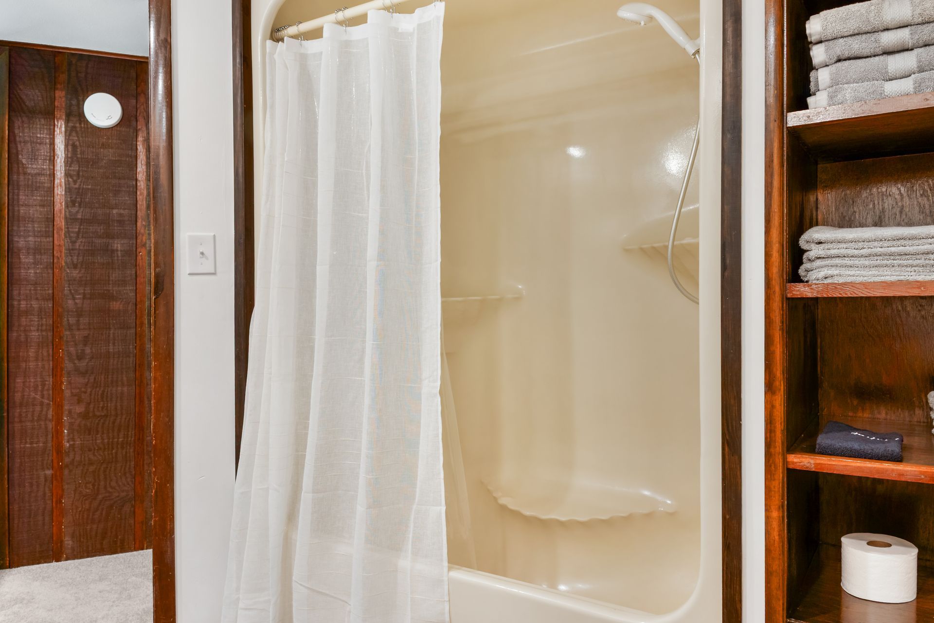 A bathroom with a bathtub and a shower curtain.