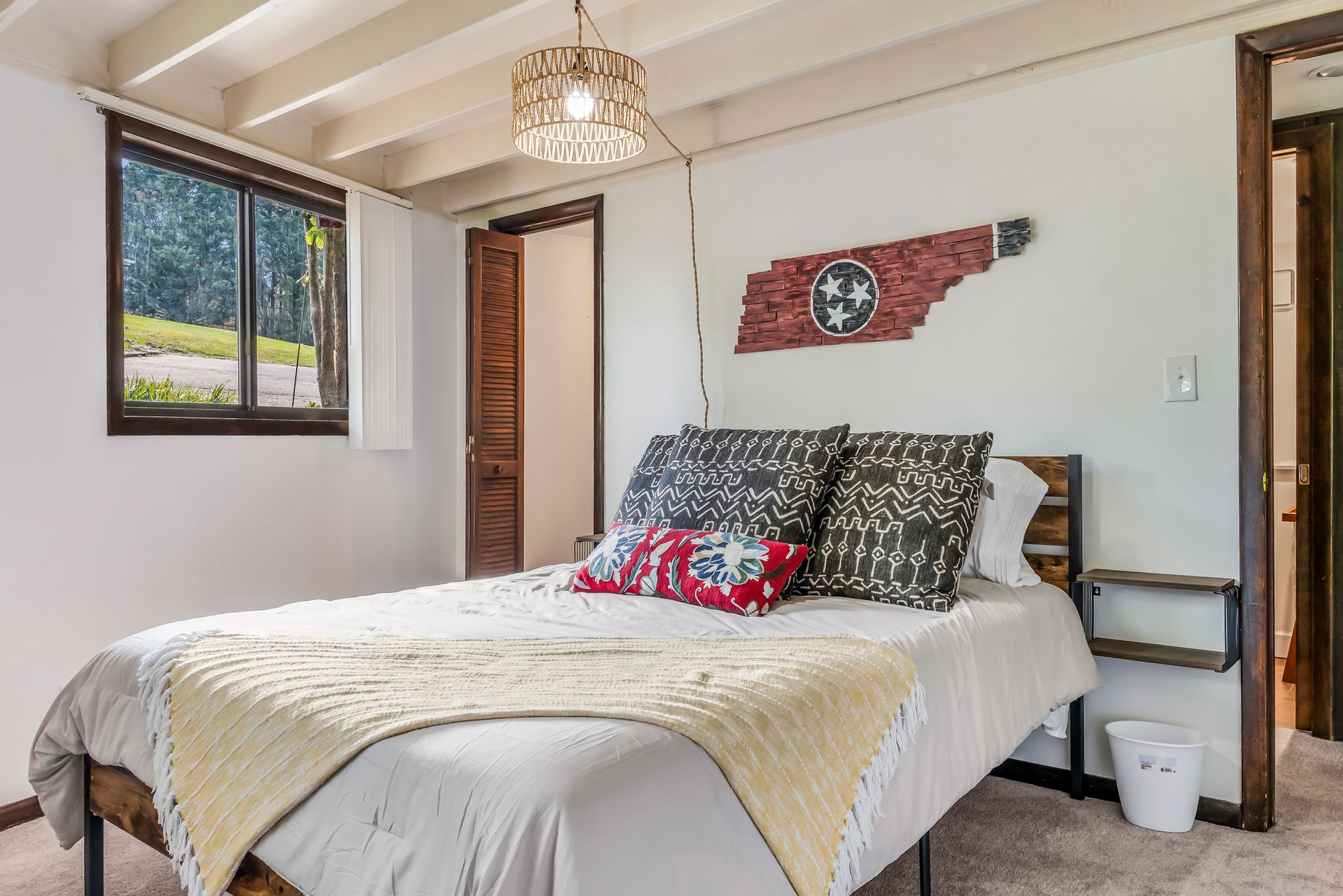 A bedroom with a bed and a flag on the wall.