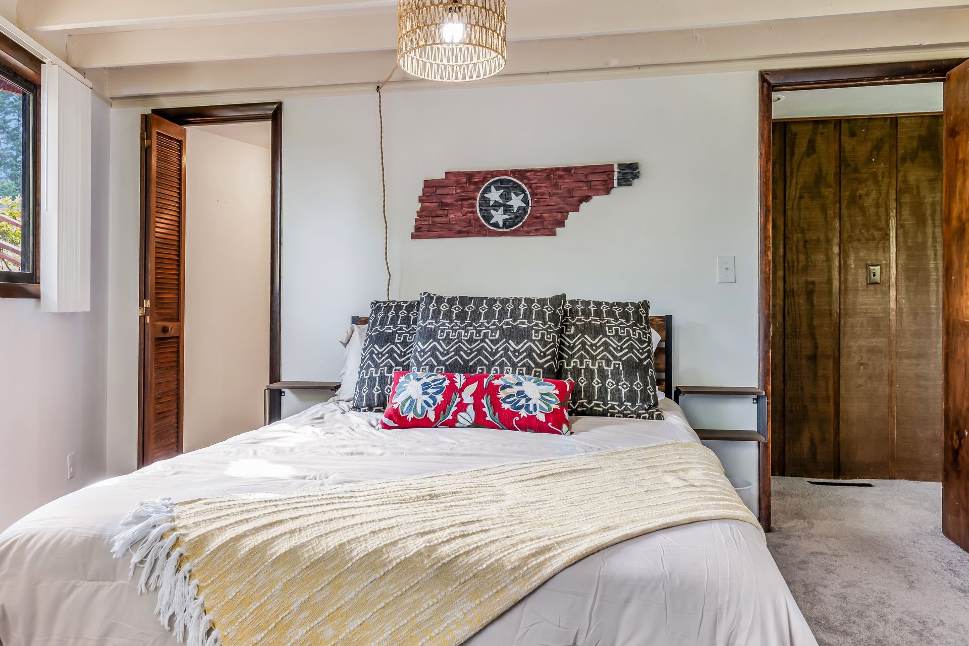 A bedroom with a bed and a flag on the wall.