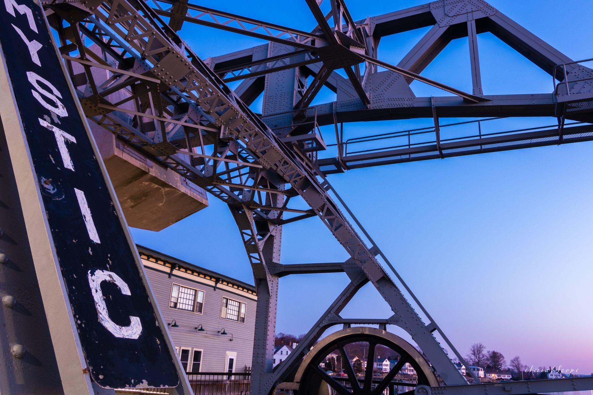 A bridge with a sign that says ' Mystic ' on it. Mystic, CT Bascule Bridge