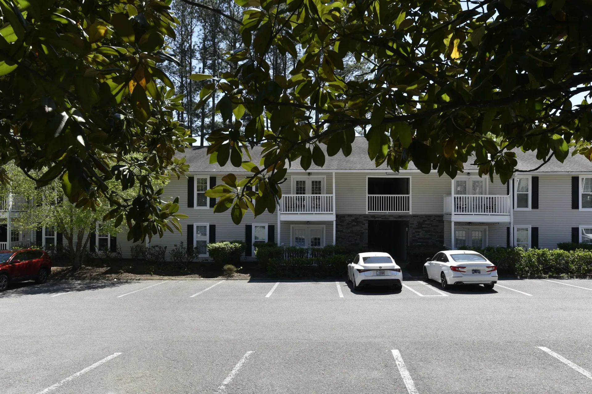 A parking lot with cars parked in front of a building. Copper Pointe, Knoxville, TN
