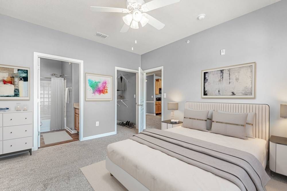 Bedroom with a large bed and a ceiling fan.