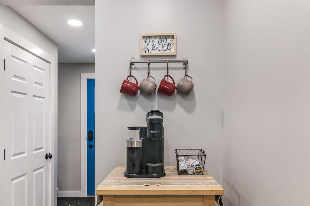 Coffee maker is sitting on top of a wooden table in a room next to a door in Mystic, CT