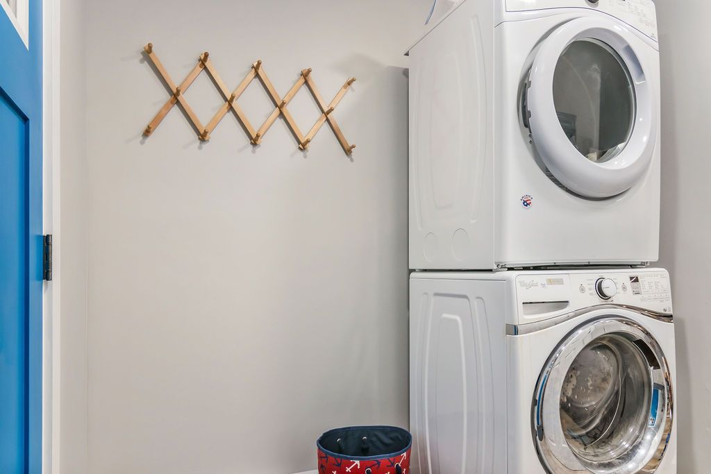 Washer and dryer are stacked on top of each other in a laundry room in Mystic, CT