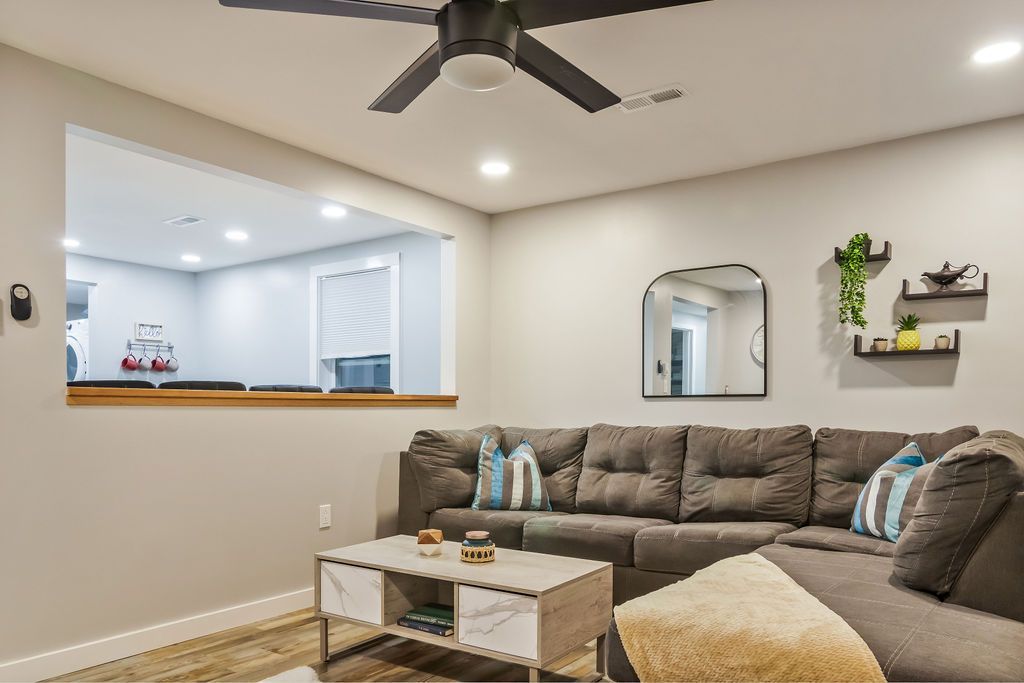 Furnished modern living room with a couch , coffee table , and ceiling fan Mystic, CT