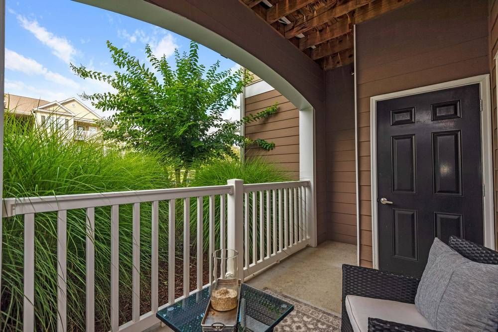 Balcony with a chair and a table on it.