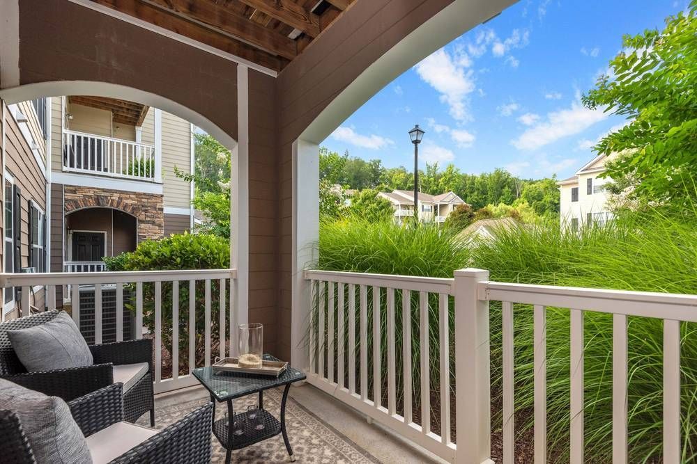 Balcony with a table and chairs on it.