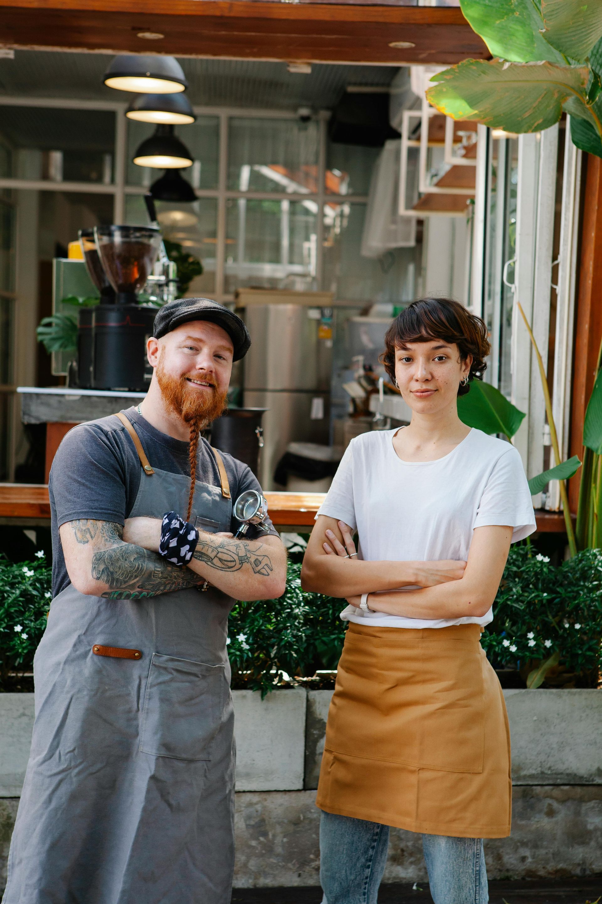 A man and a woman are standing next to each other in front of a restaurant.