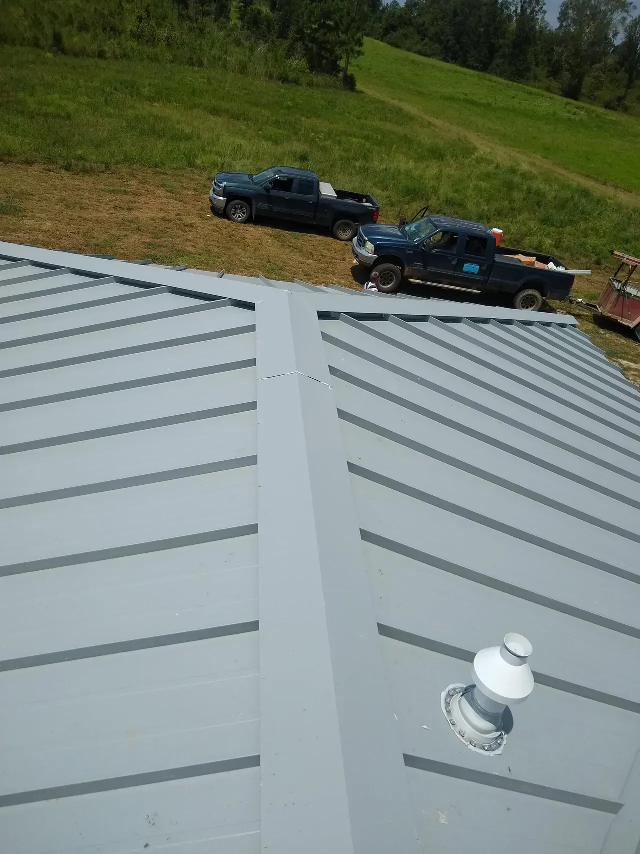 Two trucks are parked on the roof of a building.