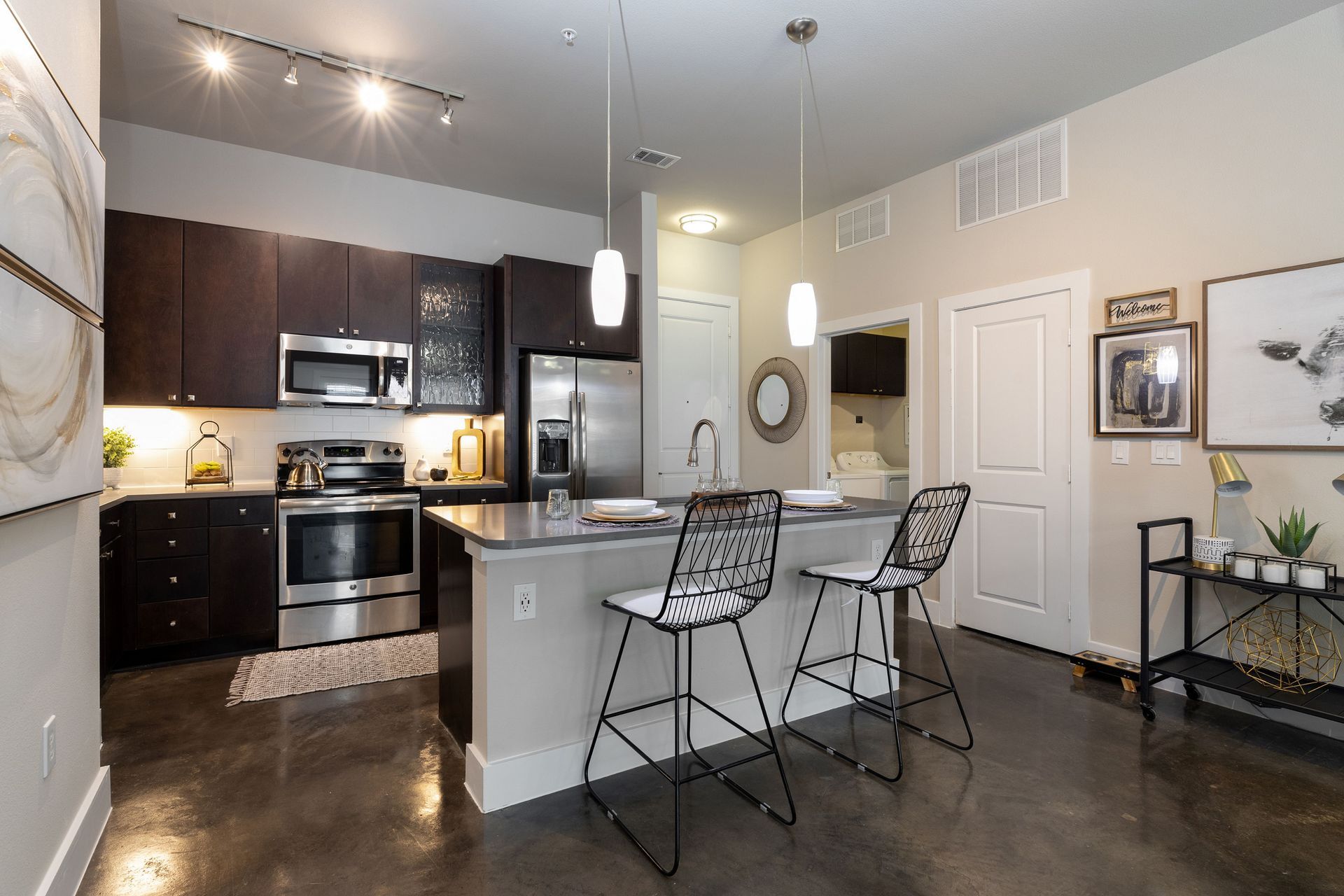 A kitchen with stainless steel appliances and a large island.