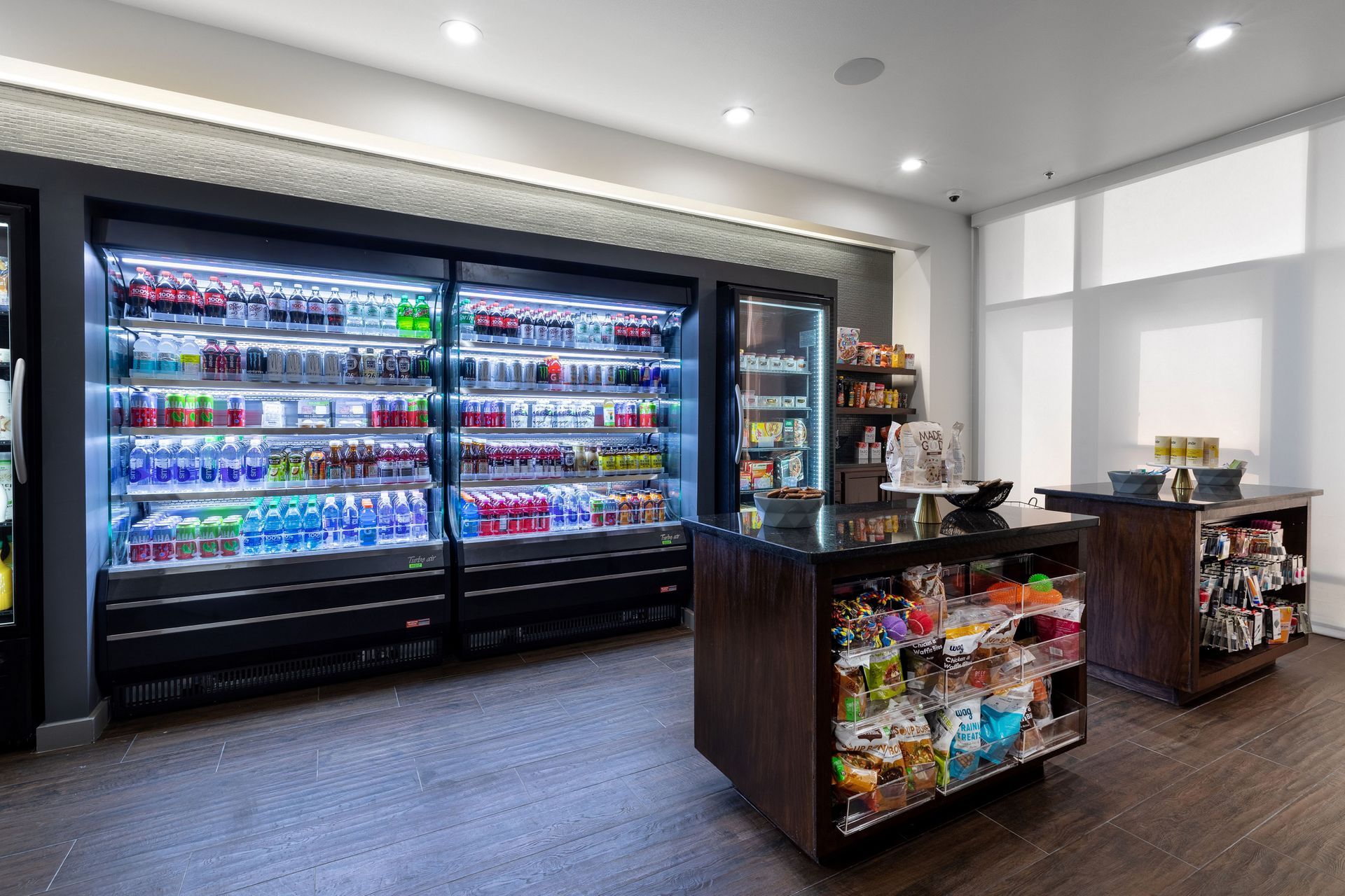 A store filled with lots of fridges and a counter.