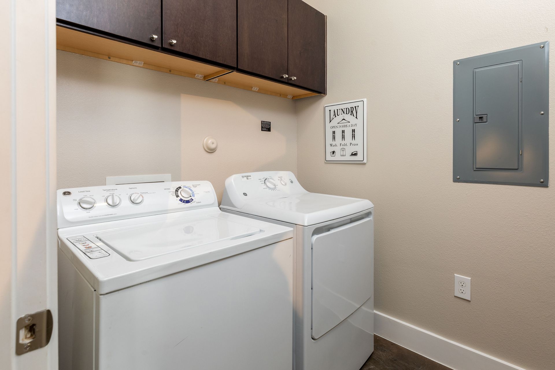 A laundry room with a washer and dryer in it.