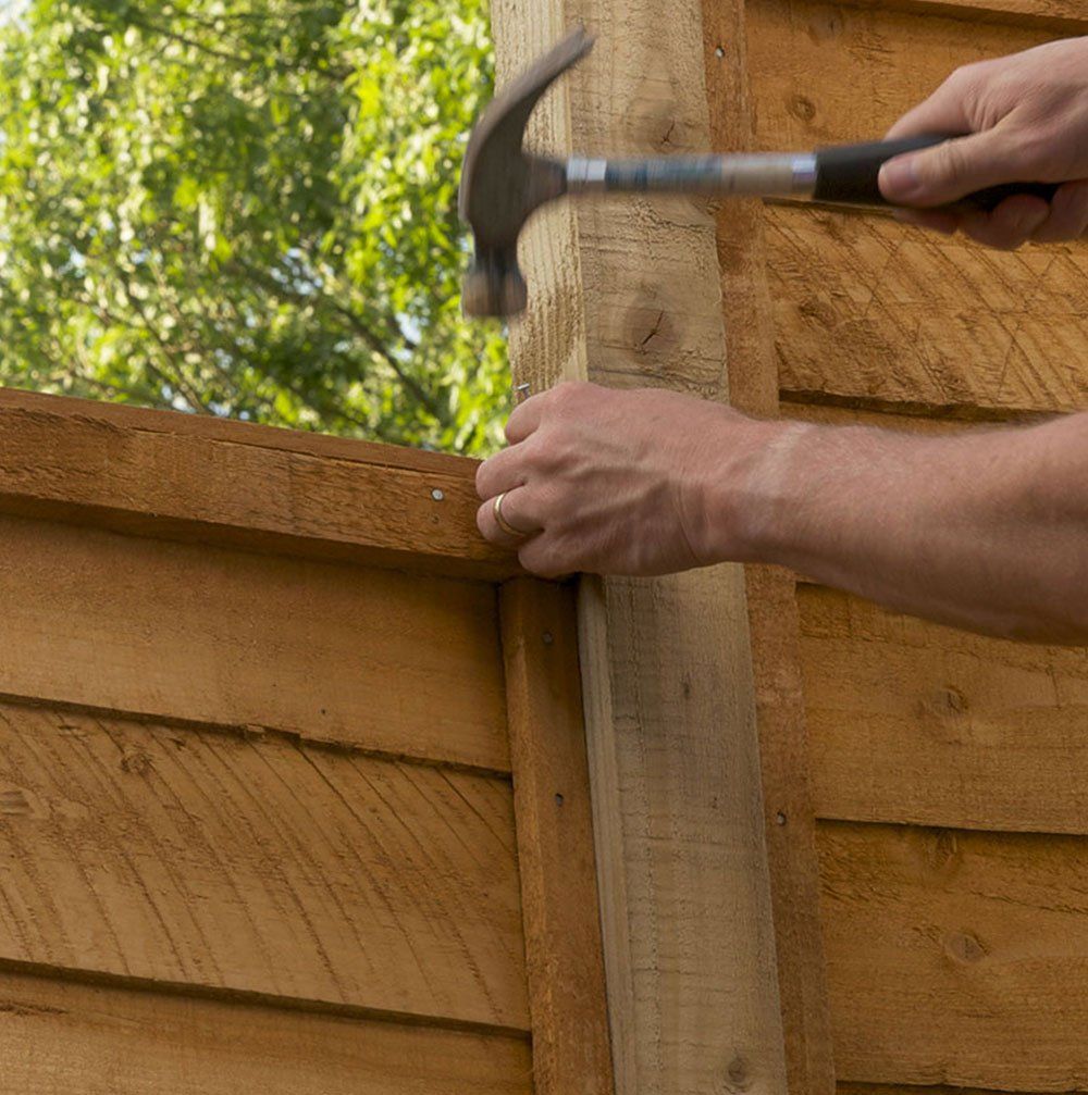 A man is painting a wall with a brush.