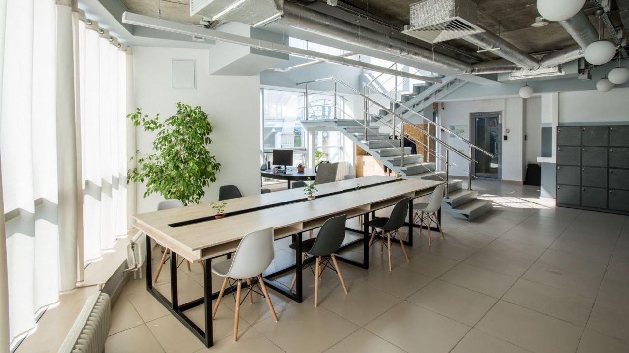 A Woman Washing a Window With a Pink Towel. Ultimate Clean Solutions Is a Nwa Cleaning Company.