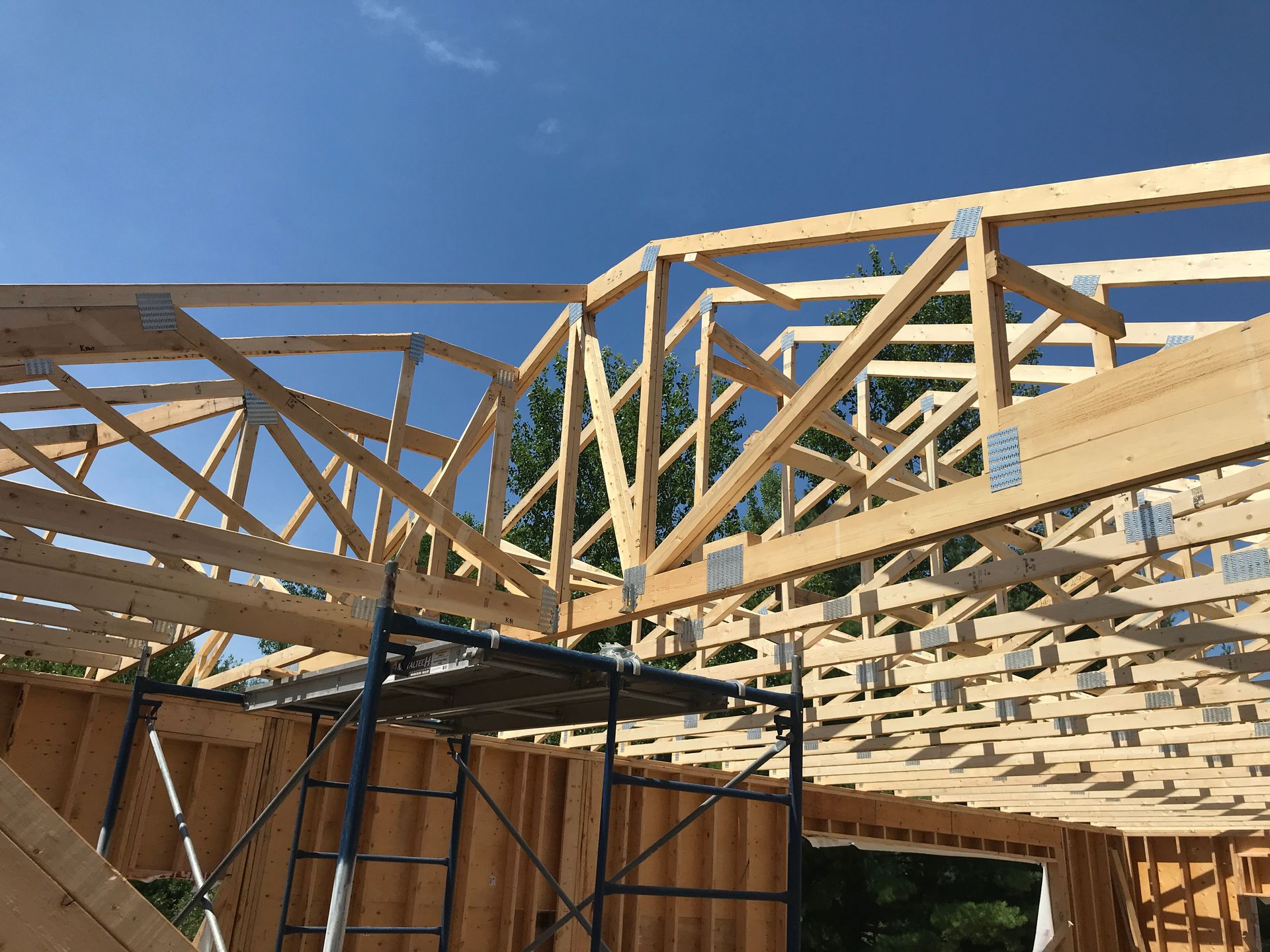 a house is being built with a lot of wooden beams .