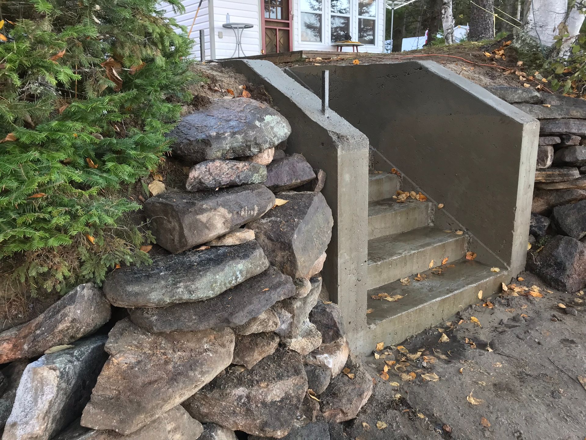 a pile of rocks is sitting next to a set of stairs .