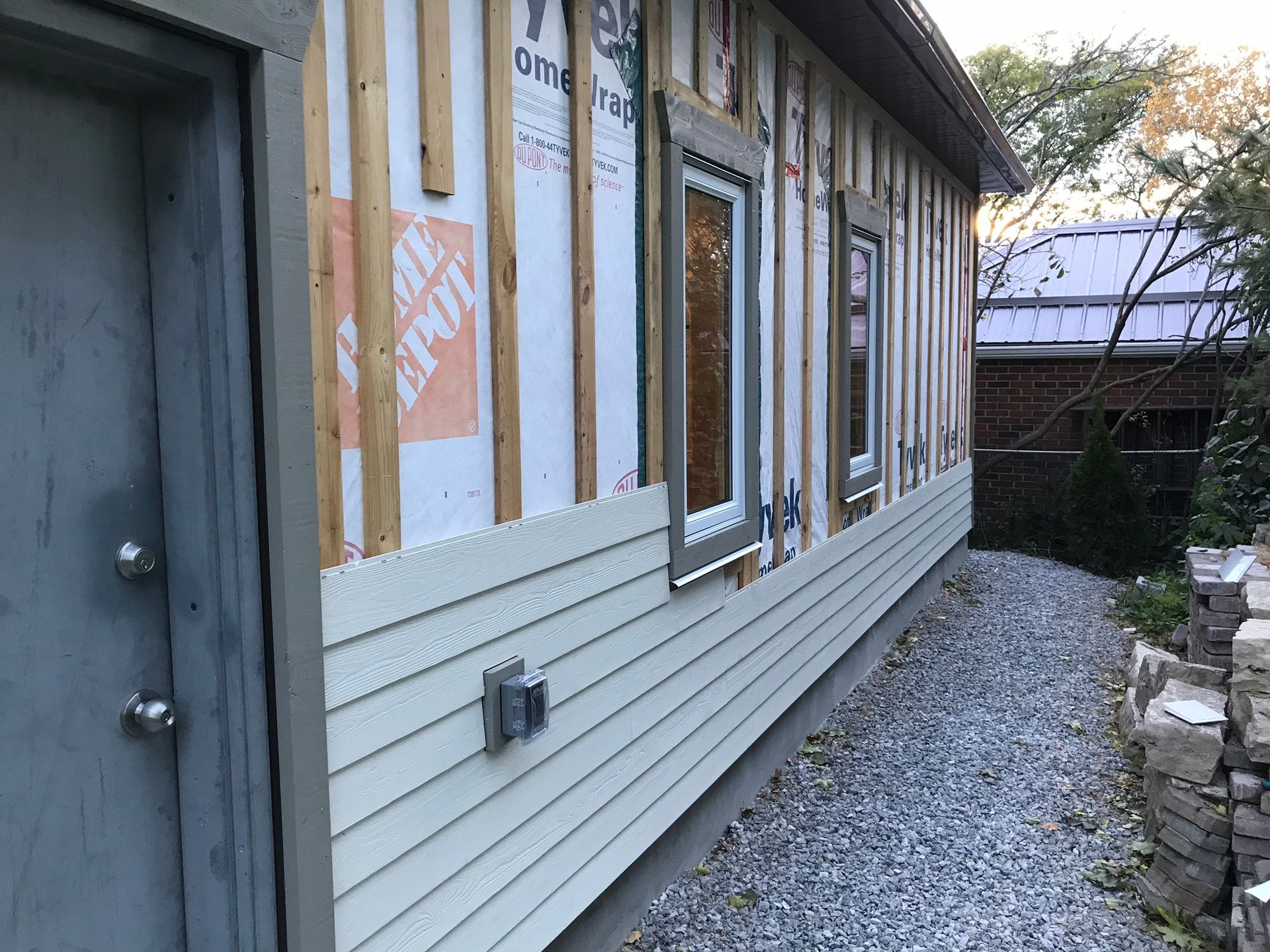 a house is being built with a lot of windows and siding .
