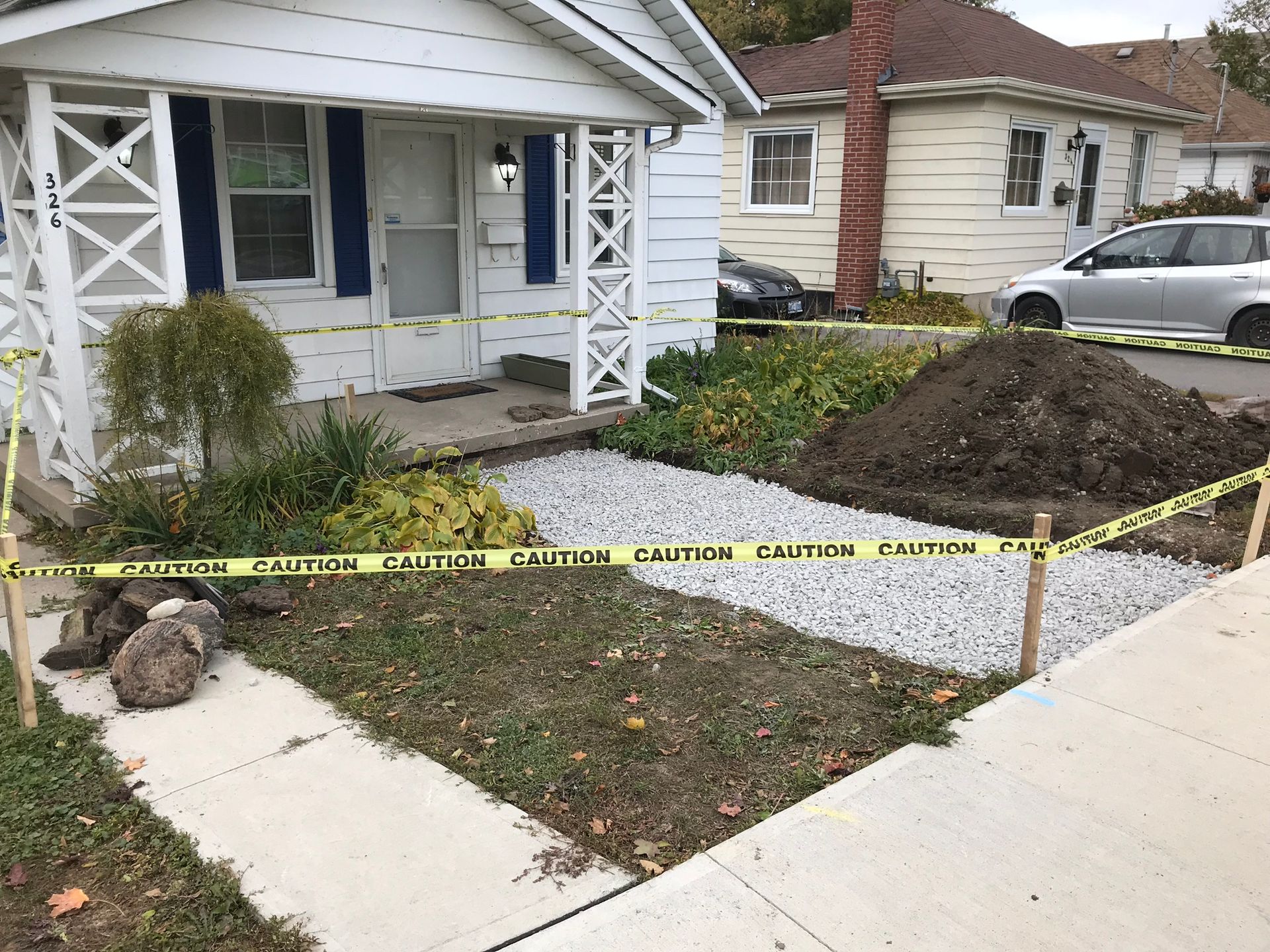 a house with a large pile of dirt in front of it .
