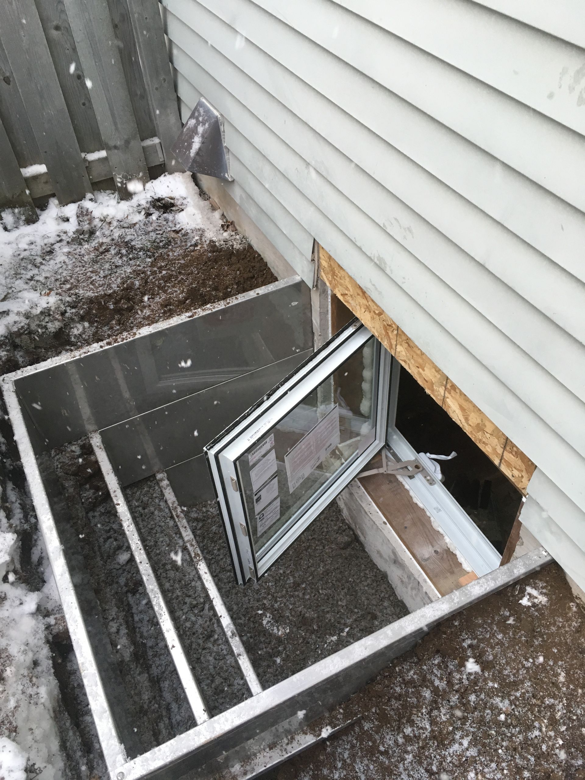 a window is open in the basement of a house