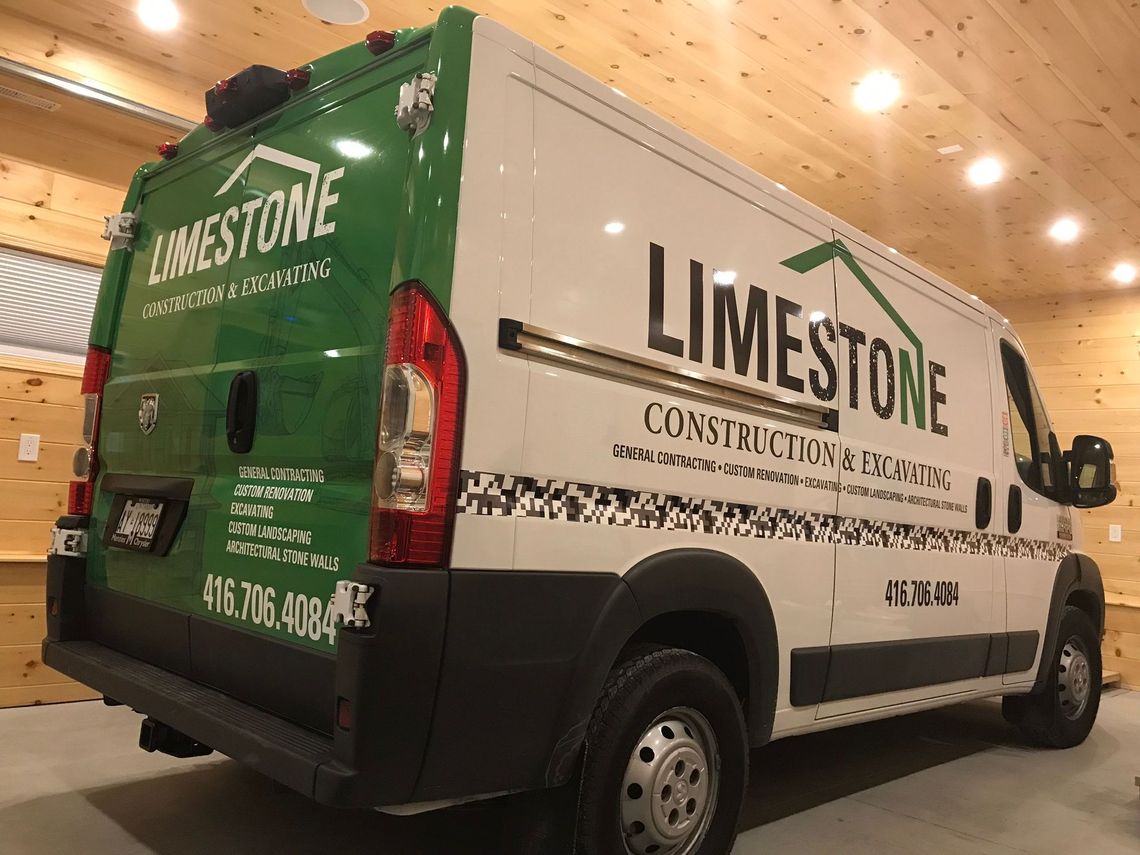 a limestone construction van is parked in a garage