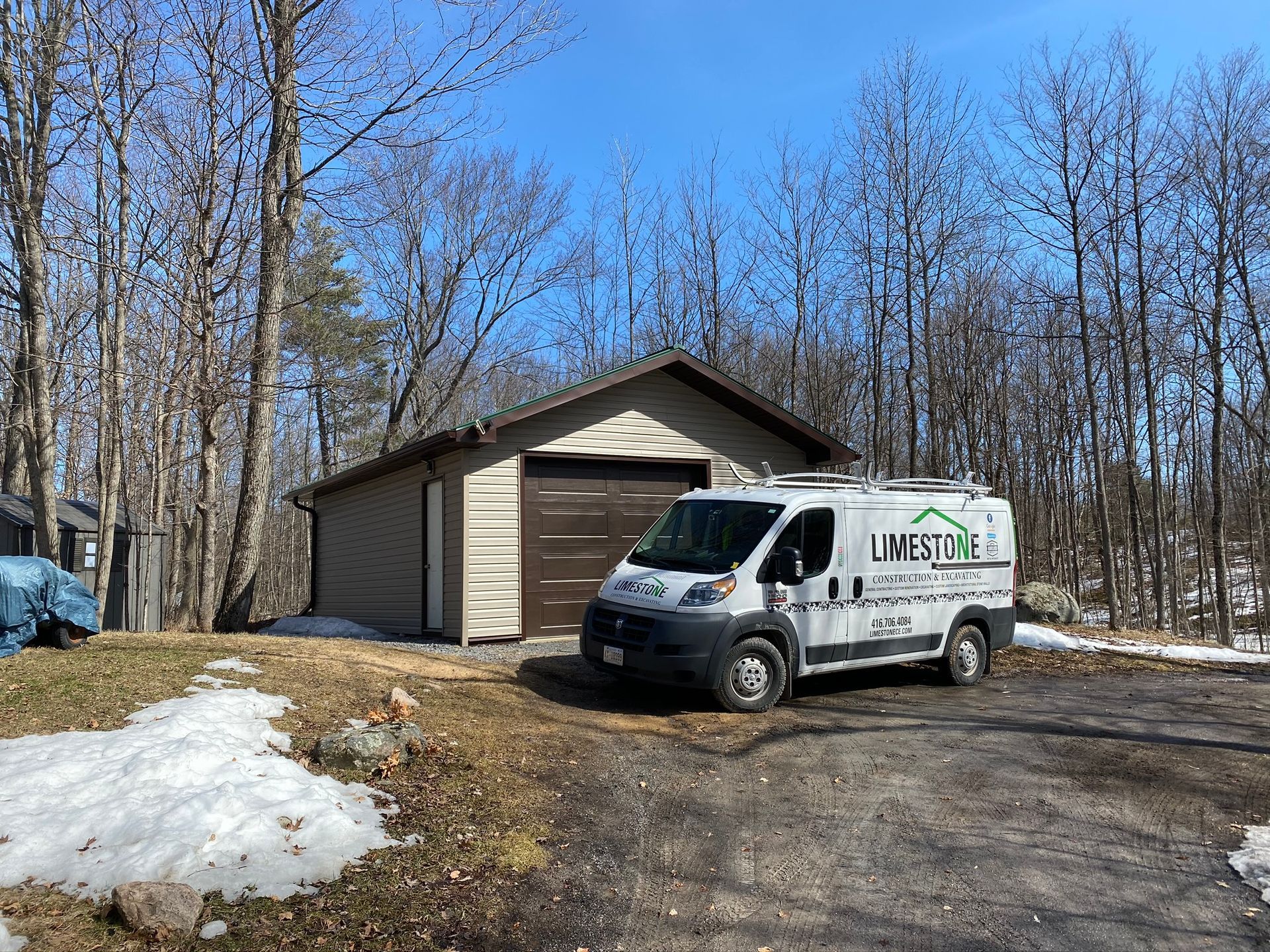 a white van is parked in front of a garage .