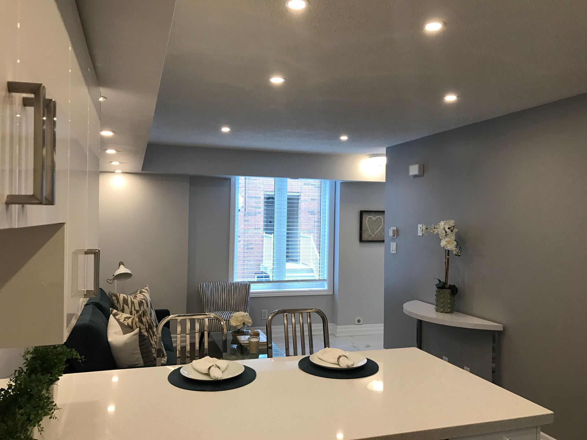 a living room with a table and chairs and a window