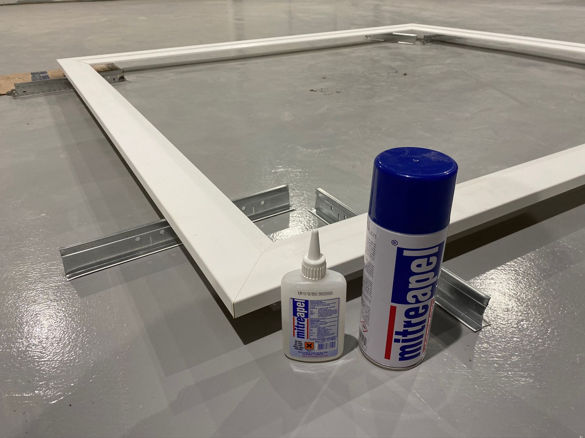 a bottle of white angel spray next to a bottle of glue .